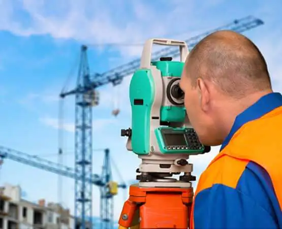 A Land Surveyor in Springfield IL using equipment to analyze a piece of land