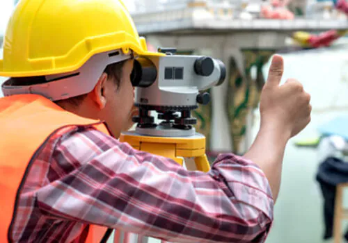 A land surveyor giving a thumbs up while providing land surveying service in Illinois