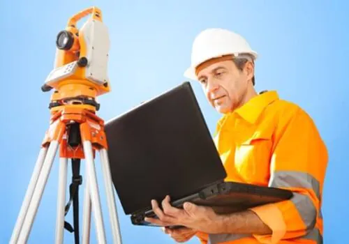A civil engineer on site and looking at data for a land survey in Illinois