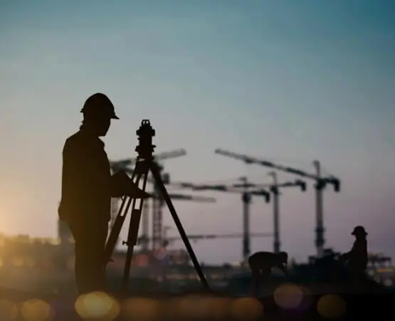 The silhouette of a civil engineering performing Land Surveying in Springfield IL