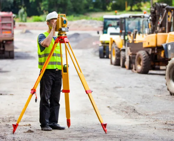 Land Surveying Peoria IL 1 A young professional helping with Land Surveying in Peoria IL, on a construction site