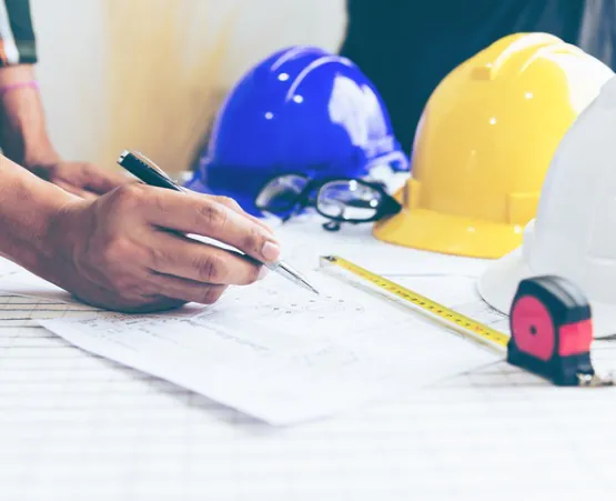Civil Engineers in East Peoria IL making notes on a blueprint for construction