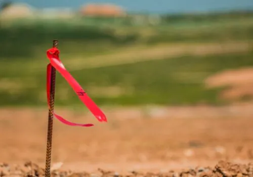 A flag in the ground for ALTA Surveys done by Austin Engineering