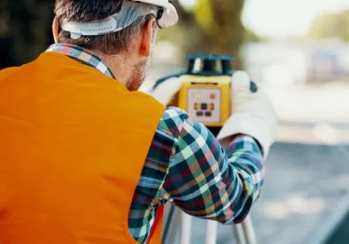 A Property Surveyor in Illinois helping inspect a piece of land