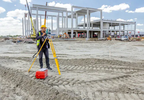 An expert from Austin Engineering performing ALTA Surveys for a commercial piece of property