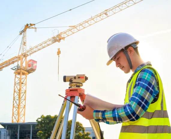 Worker performing surveying service in Peoria IL
