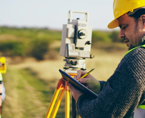 Worker performing survey work during Site Planning in Davenport IA