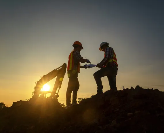 Land Developer Working in Chattanooga TN in the evening with a backhoe tractor before the sun goes down