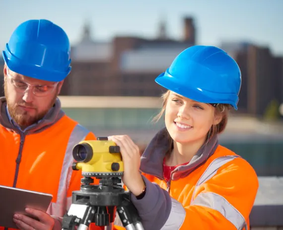Man and woman team from a Civil Engineering Firm Surveying Land in Chattanooga TN