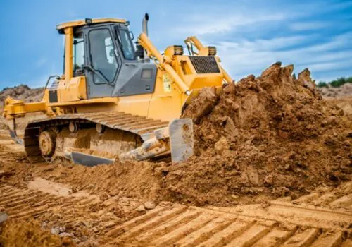 An excavator moving dirt during Local Land Development in Knoxville TN