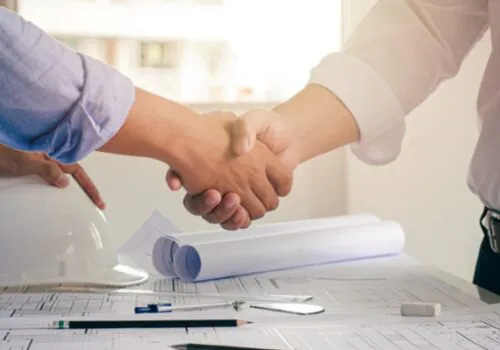 Architechs and engineers shake hands while working on Commercial Site Planning in Springfield IL