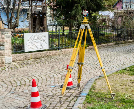 A survey tool set up along a property line, used for Residential Surveys in Springfield IL 