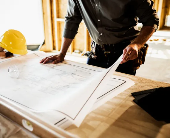 An architect reviews plans while doing Residential Site Planning in Springfield IL