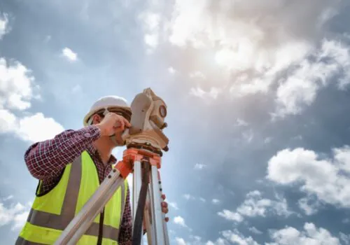 A man performing commercial surveys in front of a blue sky