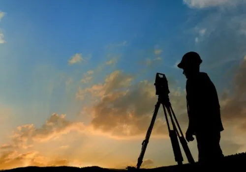 A land surveyor taking measurements for Land Development in Nashville TN