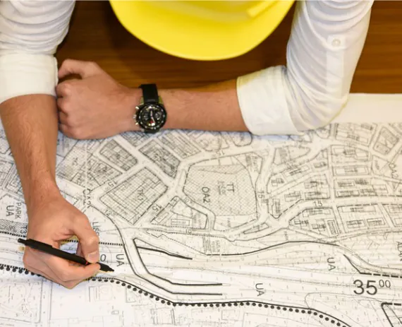 A civil engineer sketches a plan after Austin Engineering completes Commercial Surveys in Bloomington IL