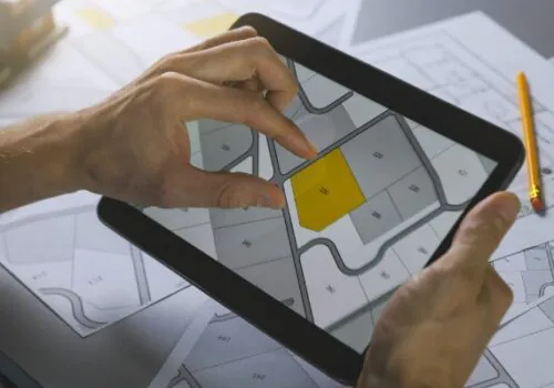 Civil engineering looking at the plans for residential land development on his tablet