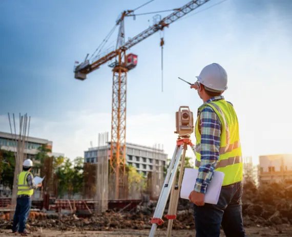 A professional from a Civil Engineering Firm in Tennessee taking measurements for a site plan, using survey equipment
