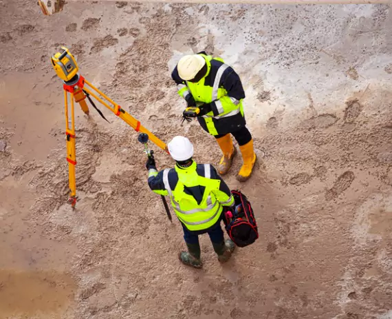 Surveyors discussing Site Layout Surveys in Springfield IL on a construction site
