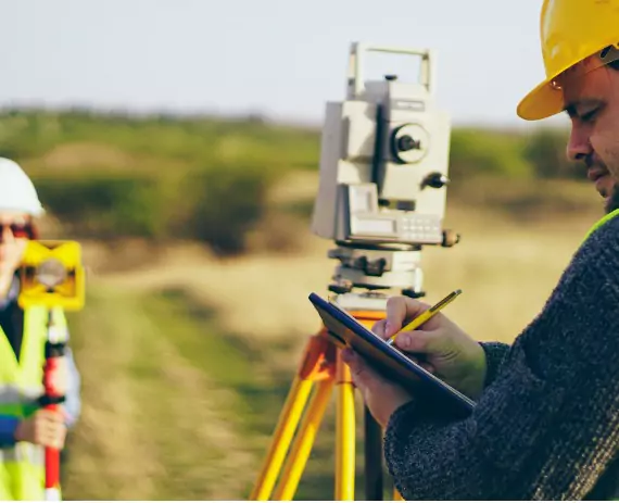A surveyor performs the duties involved in Solar Farm Surveys in Davenport IA