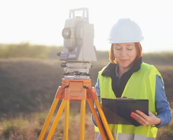 A female surveyor looking at data for Solar Farm Surveys in Springfield IL