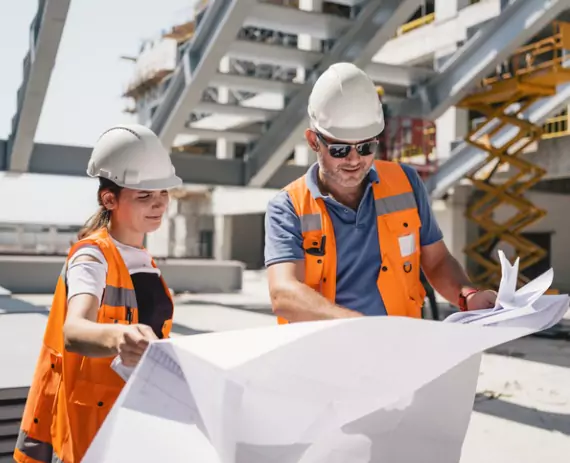 Engineers read the architectural plans for a project by Austin Engineering, a Civil Engineering Companies in Moline IL