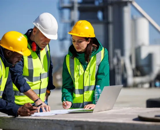 A team of project managers and engineers review notes on the job, which is one of the services Austin Engineering offers in addition to Commercial Surveys in Rock Island IL