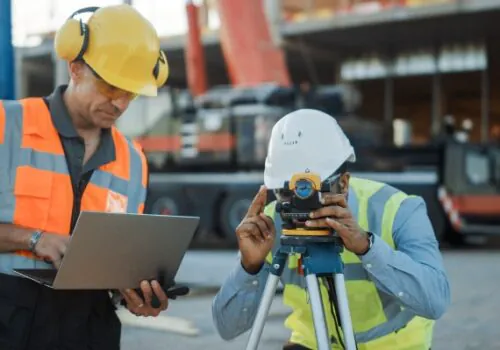 Two surveyors gathering data for commercial surveys in Iowa