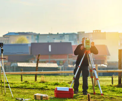 A surveyor surveys land as part of Master Planning & Urban Design Services